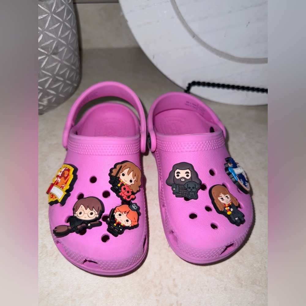 Pink toddler crocs with Harry Potter charms